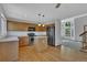 Well-lit kitchen with hardwood floors, island, black appliances, and plenty of cabinet space at 15941 Bluebonnet Dr, Parker, CO 80134
