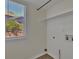 Bright laundry room with a window, white shelving, and washer hookups at 15941 Bluebonnet Dr, Parker, CO 80134
