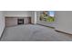 Inviting living area showcasing a charming brick fireplace and a large sunlit window at 15941 Bluebonnet Dr, Parker, CO 80134