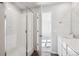 Bathroom featuring a walk-in shower with glass door, quartz counters and tile at 18958 E 94Th Pl, Commerce City, CO 80022