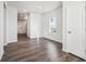 Spacious bedroom with hardwood floors, a large window, and white trim at 18958 E 94Th Pl, Commerce City, CO 80022