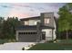 Modern two-story home with gray siding, a two-car garage, and a landscaped front yard at 18958 E 94Th Pl, Commerce City, CO 80022