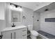 Modern bathroom features a tiled shower with niche and sleek vanity with updated fixtures at 9227 W 67Th Ave, Arvada, CO 80004
