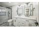 Stylish bathroom features dual vanity, modern mirrors, and a glass-enclosed shower at 9227 W 67Th Ave, Arvada, CO 80004