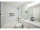 Updated bathroom features subway tile, shower-tub combo, and modern fixtures at 9227 W 67Th Ave, Arvada, CO 80004