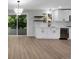 Modern kitchen with white cabinets, stainless appliances, herringbone backsplash, and an adjacent dining area at 9227 W 67Th Ave, Arvada, CO 80004