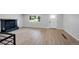 Open living room showcases modern fireplace, a bright window, and newly installed flooring at 9227 W 67Th Ave, Arvada, CO 80004