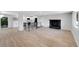 Open-concept living space featuring wood flooring, fireplace, and updated kitchen at 9227 W 67Th Ave, Arvada, CO 80004