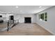 Bright, open living area with wood flooring, large windows, and modern fireplace at 9227 W 67Th Ave, Arvada, CO 80004