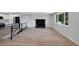 Spacious living room with a fireplace, large windows and seamlessly flowing into the kitchen area at 9227 W 67Th Ave, Arvada, CO 80004
