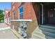 Brick multi-Gathering house with updated windows, painted stairs, and sidewalk view at 2524 Champa St # 4, Denver, CO 80205