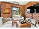 Comfortable living room with exposed brick, stylish seating, and a cozy ambiance for relaxing and entertaining guests at 2524 Champa St # 4, Denver, CO 80205