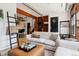 Bright living space features hardwood floors, a comfortable sofa, and seamless access to other areas in the home at 2524 Champa St # 4, Denver, CO 80205