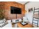 Inviting living room showcasing exposed brick, modern furnishings, and stylish decor for a cozy atmosphere at 2524 Champa St # 4, Denver, CO 80205