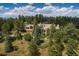 Secluded property surrounded by trees with stone retaining walls, offering privacy and a natural setting at 1682 Montane E Dr, Golden, CO 80401