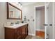Bathroom features a classic vanity with marble countertop and updated lighting at 11950 E Exposition Ave, Aurora, CO 80012