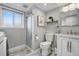 Bright bathroom showcases a glass shower, marble vanity, and updated fixtures at 11950 E Exposition Ave, Aurora, CO 80012