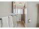 Bathroom featuring a glass shower, towel rack, tile flooring, and neutral tones at 11950 E Exposition Ave, Aurora, CO 80012