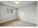 Simple bedroom featuring a neutral carpet and a window at 11950 E Exposition Ave, Aurora, CO 80012