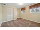 Bedroom with neutral carpet, window, and closet at 11950 E Exposition Ave, Aurora, CO 80012