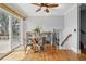 Dining area with natural light from sliding glass doors, hardwood floors, and modern furnishings at 11950 E Exposition Ave, Aurora, CO 80012