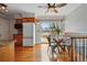 Bright dining area features hardwood floors, modern lighting, and sliding glass doors to the patio at 11950 E Exposition Ave, Aurora, CO 80012