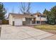 Charming home with an attached garage, a well-maintained lawn, and a cozy front porch at 11950 E Exposition Ave, Aurora, CO 80012
