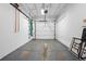 Spacious garage with white walls and a roll-up door at 11950 E Exposition Ave, Aurora, CO 80012