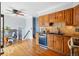 View of the kitchen and dining area with hardwood floors and classic oak cabinetry at 11950 E Exposition Ave, Aurora, CO 80012