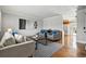 Comfortable living room includes hardwood floors, neutral paint colors, and a view of the kitchen at 11950 E Exposition Ave, Aurora, CO 80012