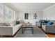 Inviting living room showcasing hardwood floors, bright windows, and elegant furnishings at 11950 E Exposition Ave, Aurora, CO 80012