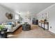 Spacious living room features neutral decor, plush carpeting, and stylish accents at 11950 E Exposition Ave, Aurora, CO 80012