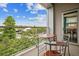Cozy balcony features a small table with chairs and peaceful views of the green surroundings at 2958 Syracuse St # 317, Denver, CO 80238