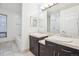 Bright bathroom with double sinks, granite countertop, a soaking tub, and a separate shower at 2958 Syracuse St # 317, Denver, CO 80238