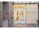 Exterior of the building entrance with signage and brick facade at 2958 Syracuse St # 317, Denver, CO 80238