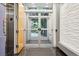 Building entrance with a glass door, elevator, and textured wall at 2958 Syracuse St # 317, Denver, CO 80238