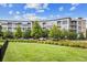 Apartment building with well-maintained landscaping, greenery, and mature trees at 2958 Syracuse St # 317, Denver, CO 80238