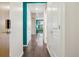 Hallway showcasing hardwood floors, white walls, and multiple doors leading to various rooms at 2958 Syracuse St # 317, Denver, CO 80238
