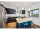 Modern kitchen with granite countertops, stainless steel appliances, and dark cabinets at 2958 Syracuse St # 317, Denver, CO 80238