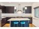 Modern kitchen with granite countertops, stainless steel appliances, and stylish dark cabinets at 2958 Syracuse St # 317, Denver, CO 80238