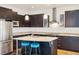Modern kitchen with granite countertops, stainless steel appliances, and dark cabinets at 2958 Syracuse St # 317, Denver, CO 80238