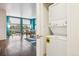 View of open living space from hallway features turquoise accent wall and large window at 2958 Syracuse St # 317, Denver, CO 80238