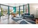 Bright living space with hardwood floors, modern furniture, and large windows with neighborhood views at 2958 Syracuse St # 317, Denver, CO 80238