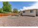 Backyard featuring a concrete patio area, gravel, and a wooden privacy fence providing space for outdoor enjoyment at 3501 W 53Rd Ave, Denver, CO 80221