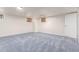 Spacious basement with neutral carpet, simple windows, and white walls offering a versatile living space at 3501 W 53Rd Ave, Denver, CO 80221
