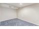 Unfinished basement space with neutral carpet, white walls, and simple lighting for potential customization at 3501 W 53Rd Ave, Denver, CO 80221