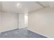 Unfinished basement area with neutral carpet and a white door leading to another part of the house at 3501 W 53Rd Ave, Denver, CO 80221