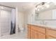 Bright bathroom featuring a granite vanity, tiled shower, and updated fixtures at 3501 W 53Rd Ave, Denver, CO 80221