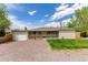 Delightful single-story home featuring a covered front porch and a spacious gravel driveway for parking at 3501 W 53Rd Ave, Denver, CO 80221