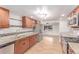 Updated kitchen with stainless appliances, granite counters, and light wood floors offers a modern and spacious design at 3501 W 53Rd Ave, Denver, CO 80221